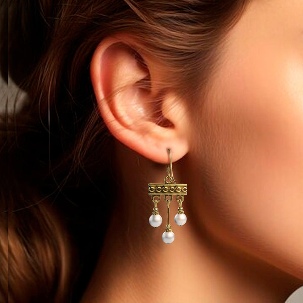 Crotalia earrings with three silver pendants worn