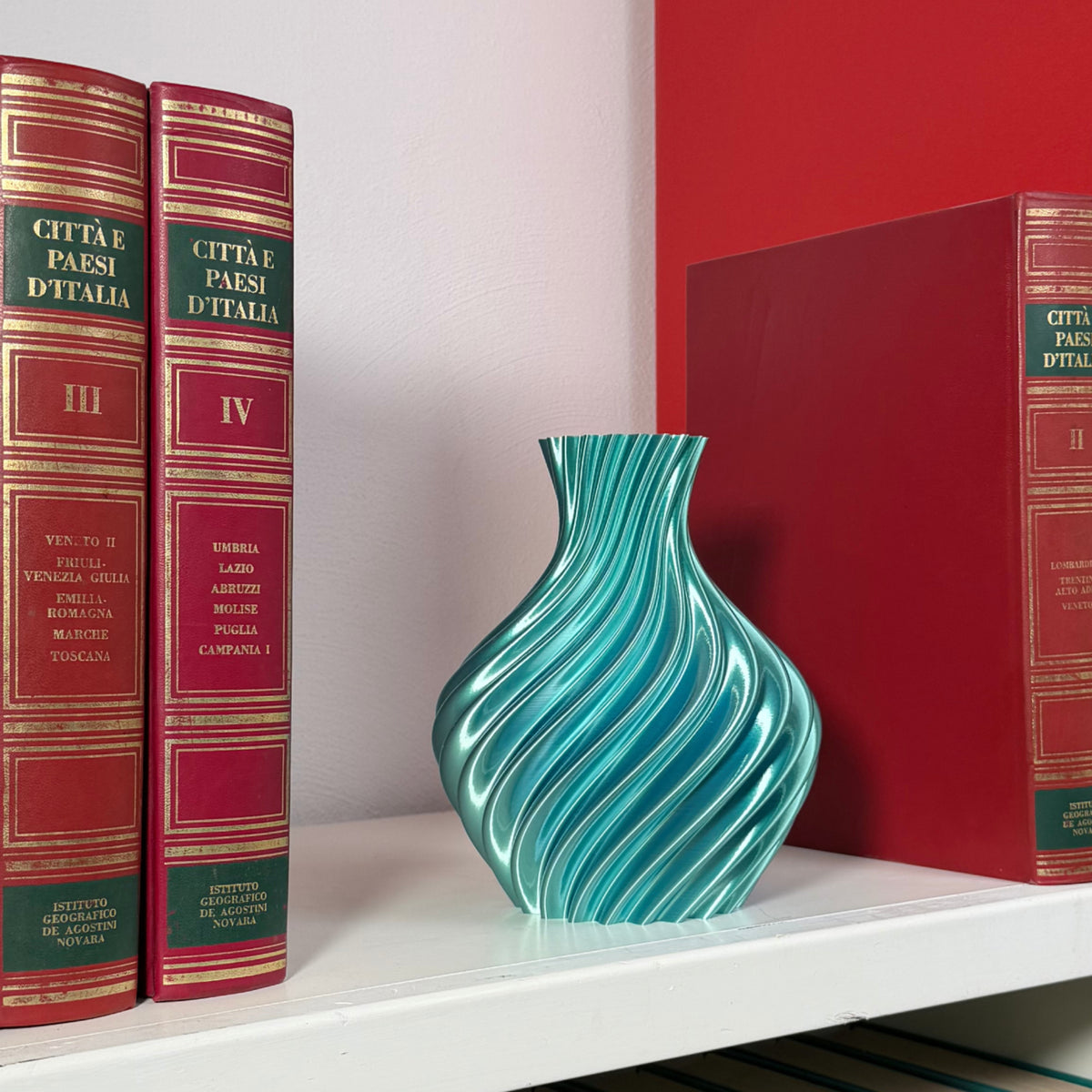 Blue/tiffany vase on shelf with books