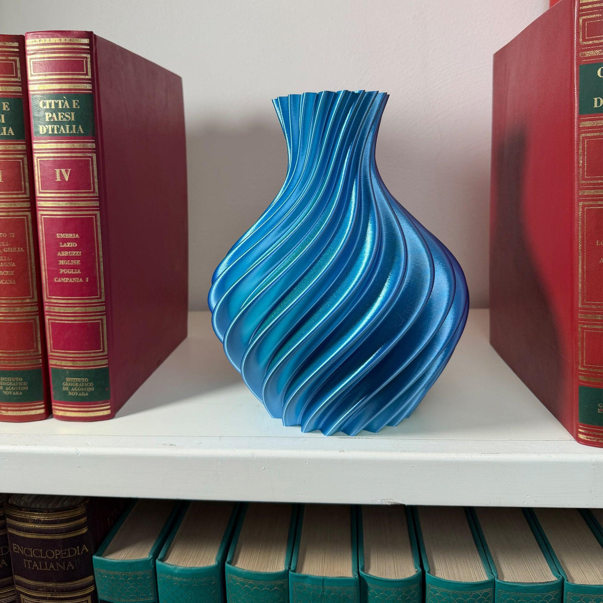 Blue/tiffany vase on shelf with books