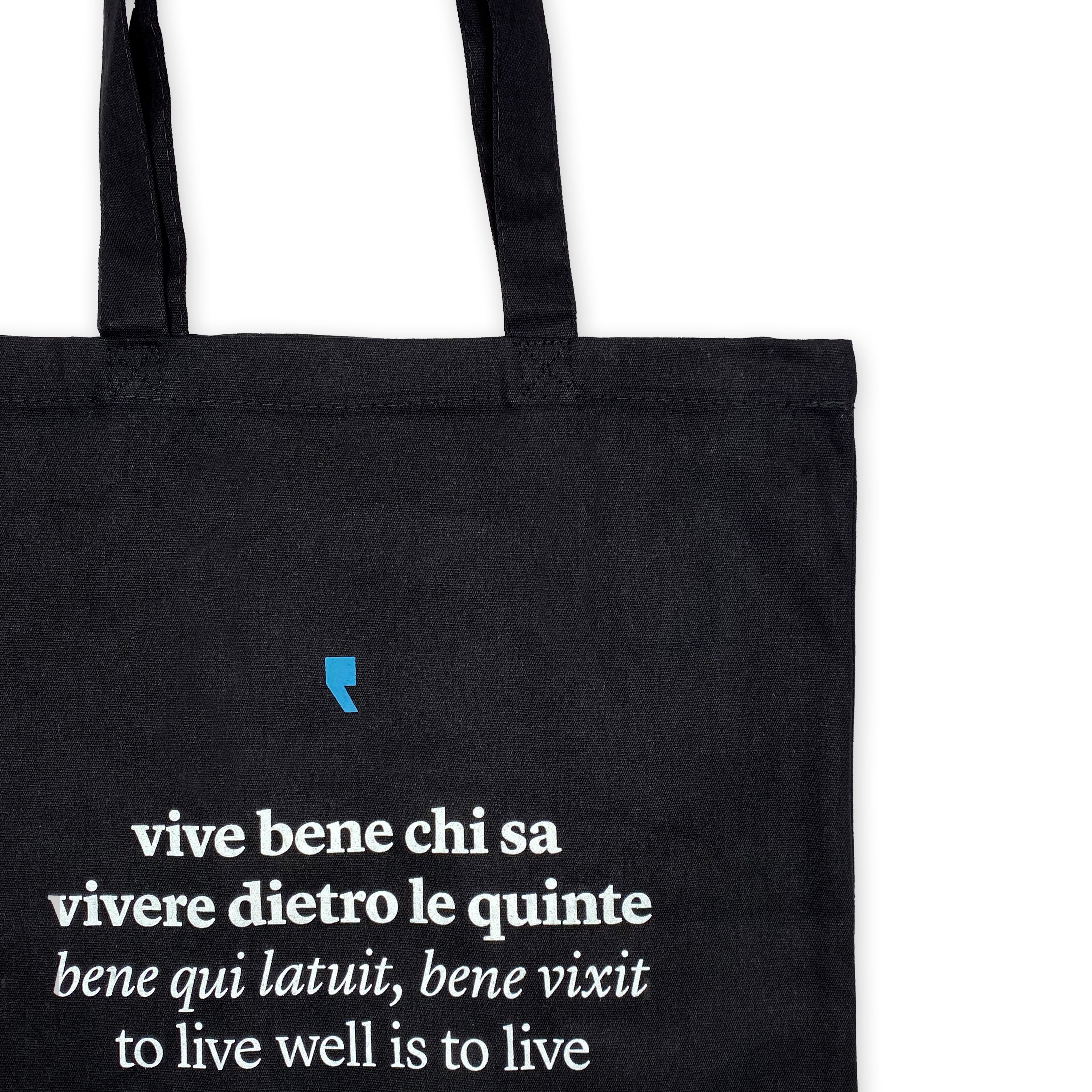 Detail of the quote "Beauty is a fragile good" printed in white on black cotton shopper – poetic phrase by Ovid